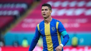 Cristiano Ronaldo wearing a blue and yellow football jersey on the field.