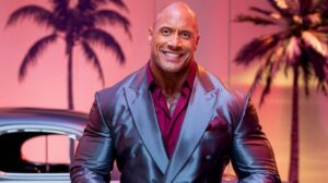 Dwayne Johnson Net Worth: Dwayne "The Rock" Johnson wearing a sleek metallic suit with palm trees and a vintage car in the background.