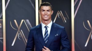 Cristiano Ronaldo in a navy blue suit at an event.