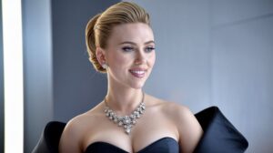 Scarlett Johansson wearing a glamorous black dress and a stunning diamond necklace, smiling elegantly.